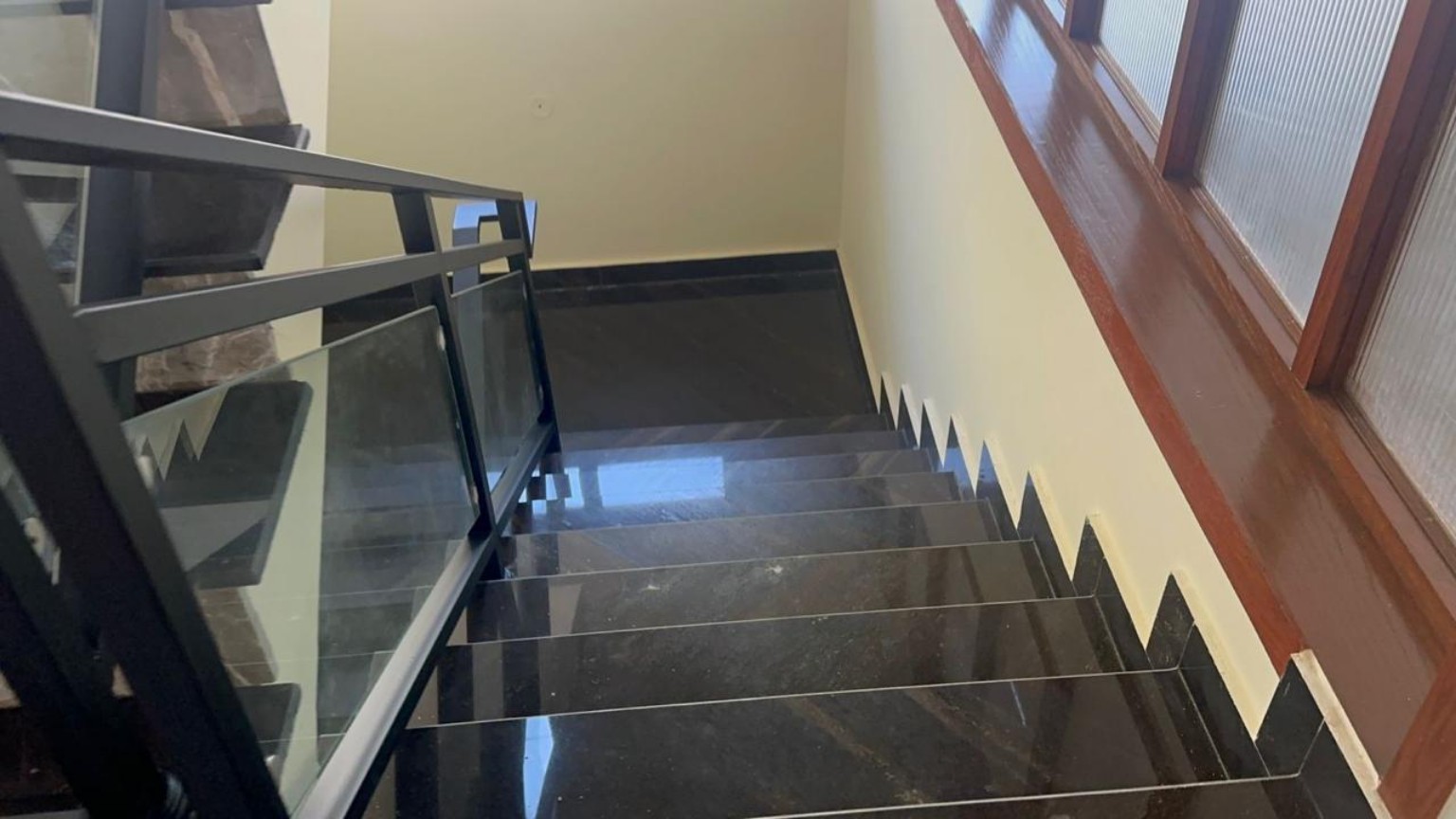 Finished dark stone staircase and railing detail