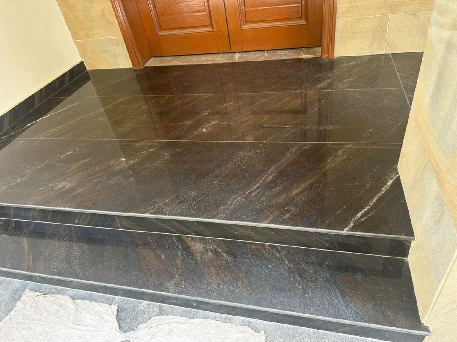 Finished dark stone landing and stair flight